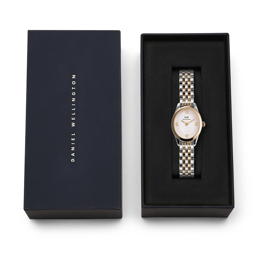 Tofarget armbåndsur i gull og sølv med hvit urskive og romertall, vist forfra mot hvit bakgrunn.