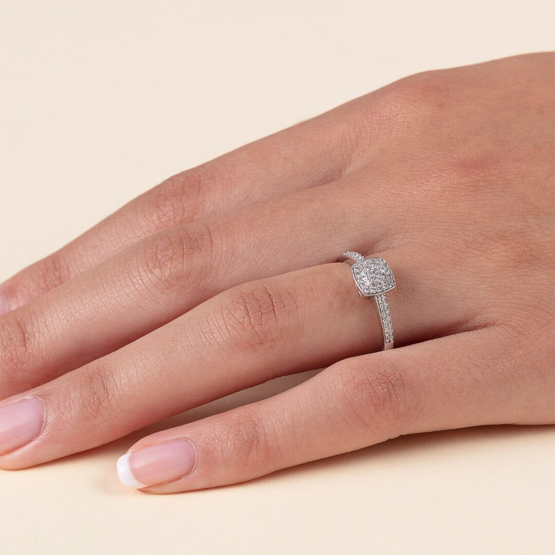 Vedlikehold av diamantene Et nærbilde av en godt vedlikehold kvinnehånd med diamantring. Dette er en ring med mange små diamanter dantert utover hele ringen.